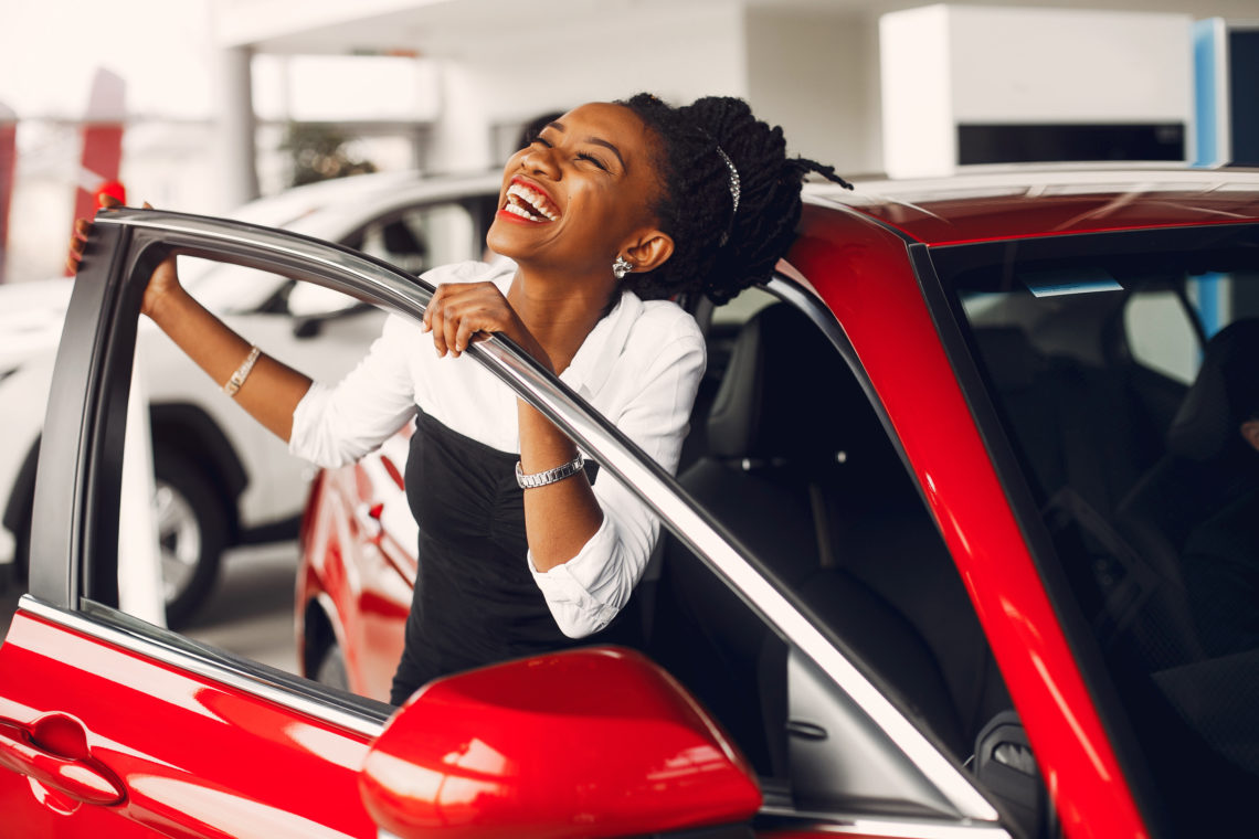 Happy car buyer in showroom